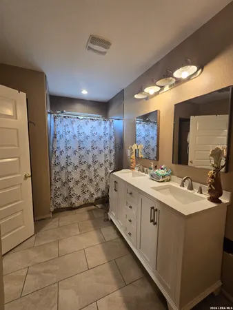 a bathroom with a sink a mirror and a shower