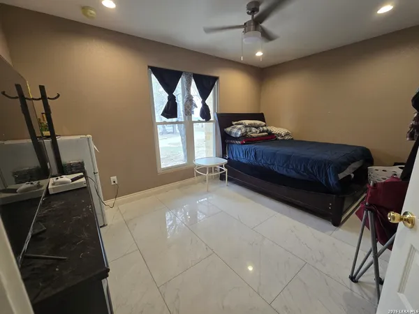a bedroom with a bed and a window