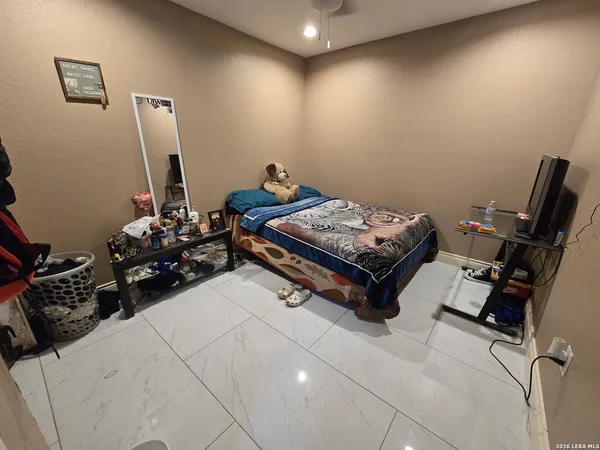 a room with gym equipment and a wooden floor