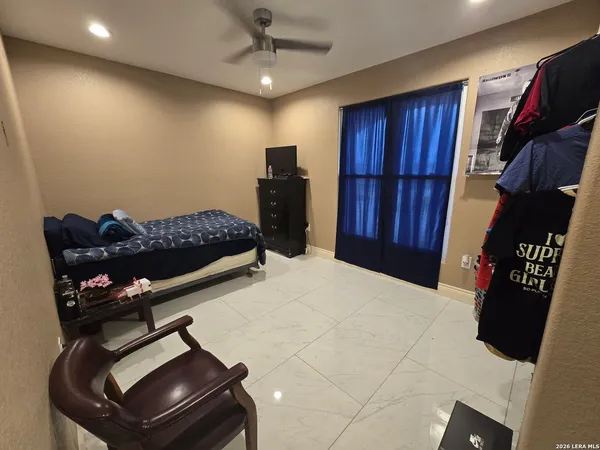 a bedroom with a bed closet and wooden floor