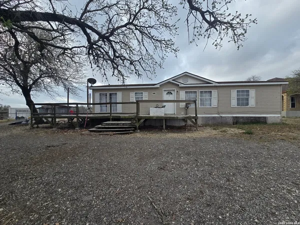 a view of a house with a large tree and a big yard