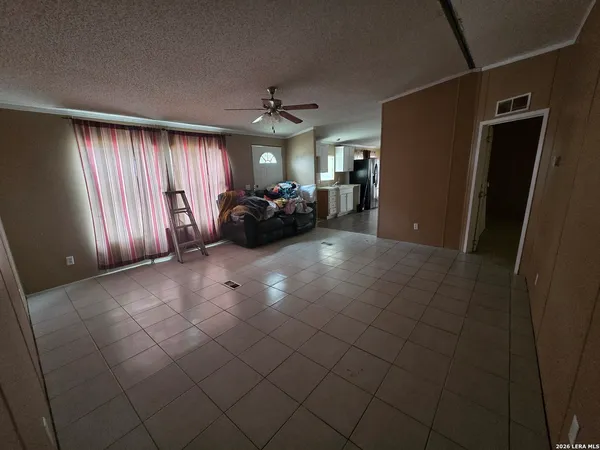 a view of a livingroom with furniture and a window