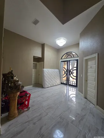 an empty room with windows and wooden floor