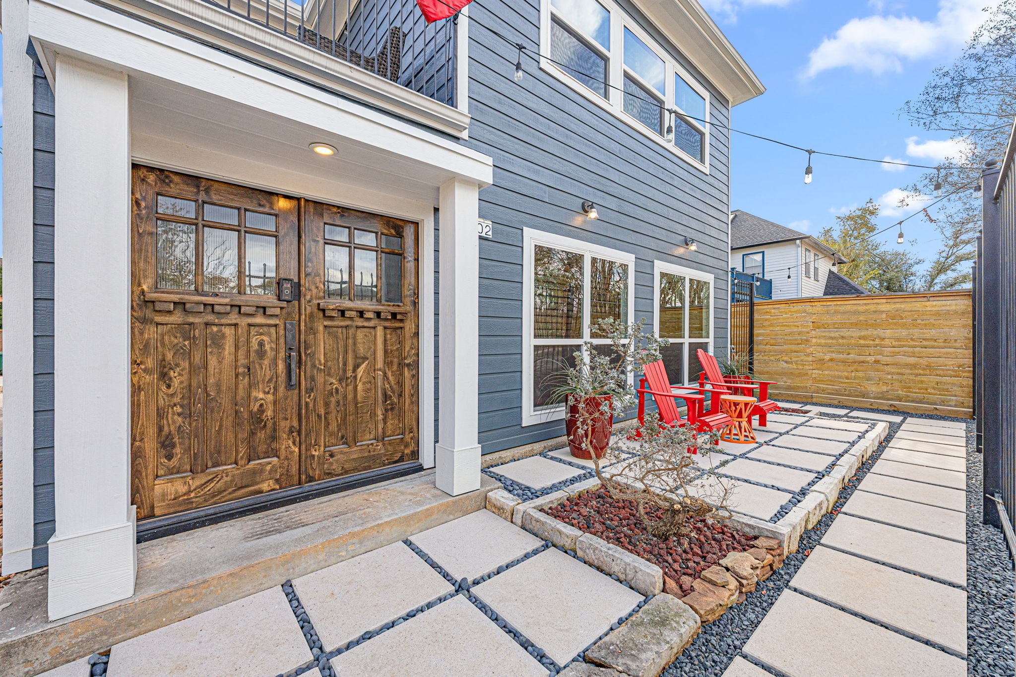 202 East 7th Street Houston, TX 77007 - Photo 2 of 27 Private front patio with modern hardscaping and seating area, offering a welcoming outdoor space just off the main entrance. Overlooks the hike and bike trail.