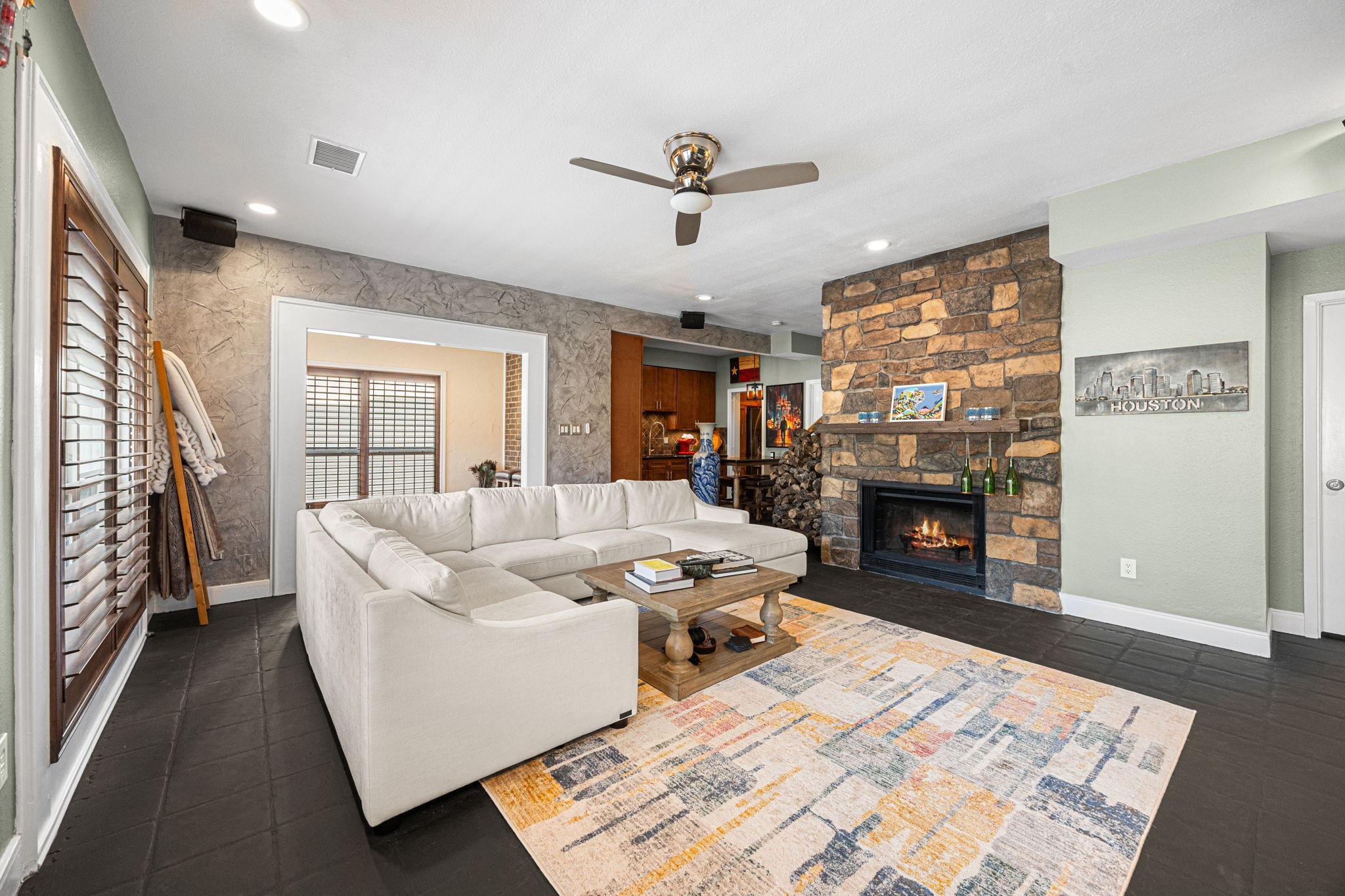 202 East 7th Street Houston, TX 77007 - Photo 3 of 27 Comfortable living room centered around a stone fireplace, creating a cozy yet modern gathering space.
