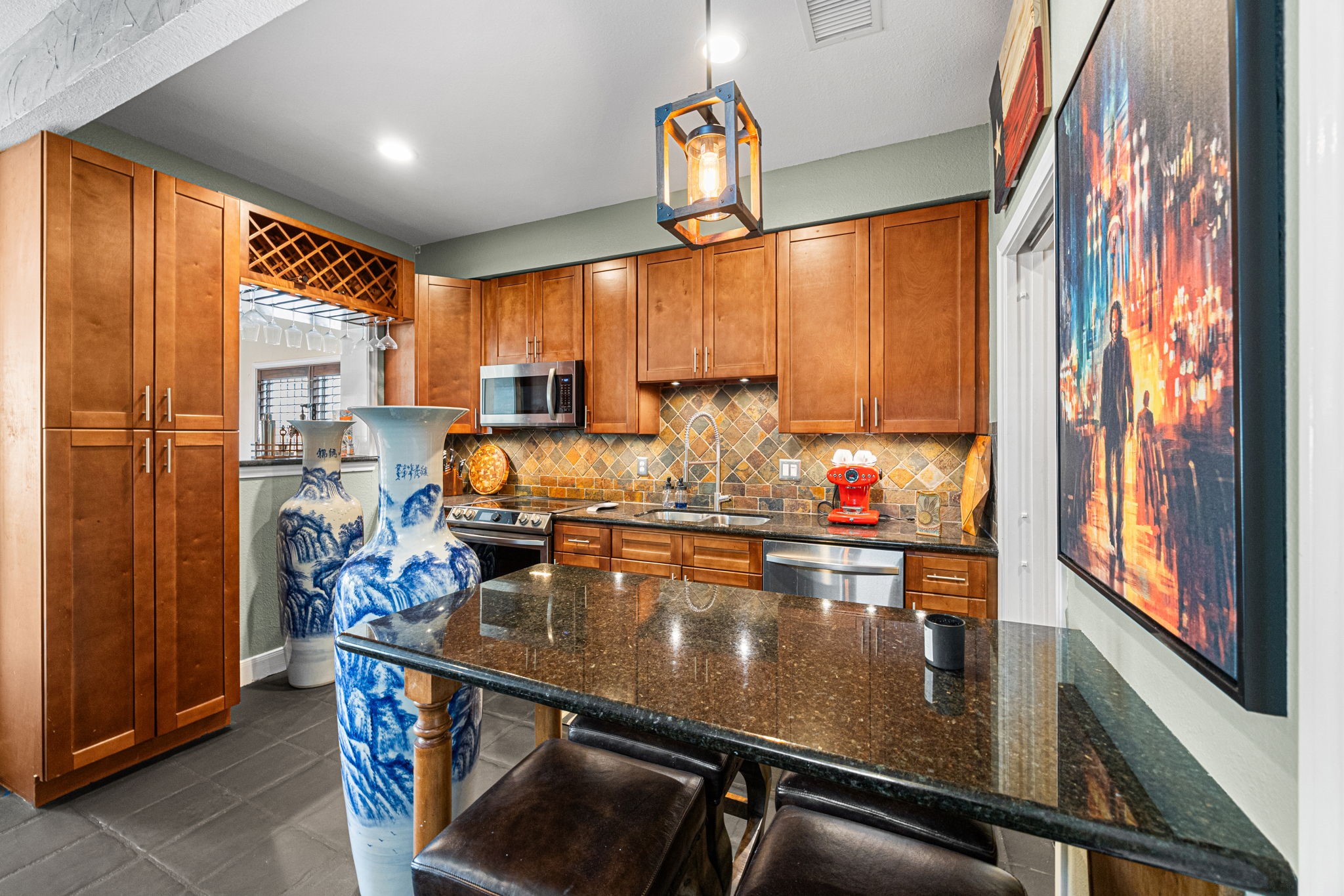 202 East 7th Street Houston, TX 77007 - Photo 6 of 27 Spacious kitchen island with bar seating, perfect for everyday meals or hosting guests, accented by custom cabinetry and statement lighting.