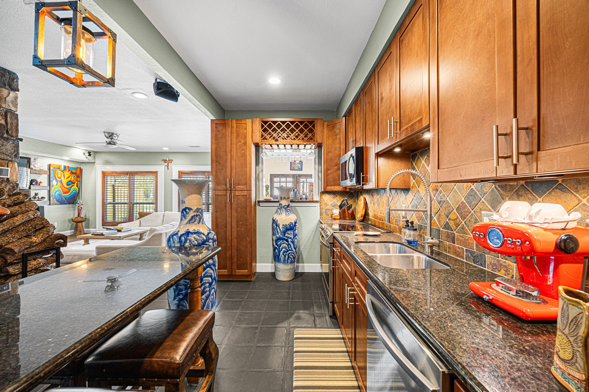 202 East 7th Street Houston, TX 77007 - Photo 7 of 27 Open-concept kitchen with granite countertops, modern lighting, and a stylish pass-through ideal for entertaining or casual dining.