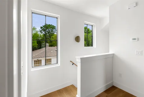 a view of an entryway with wooden floor and front door