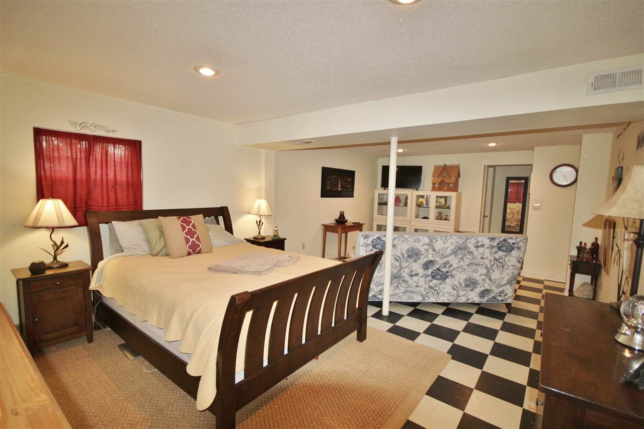 201 William Road Ruckersville, VA 22968 - Photo 16 of 23 a spacious bedroom with a bed and a lamp on dresser