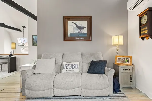 a living room with furniture and a lamp