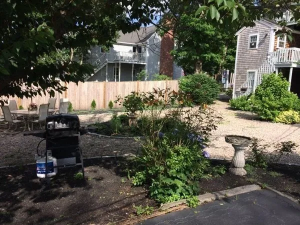 a backyard of a house with yard barbeque oven and outdoor seating