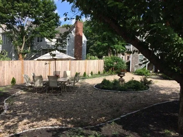 a view of a swimming pool with a chairs and table in the patio