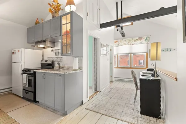 a kitchen with refrigerator and cabinets