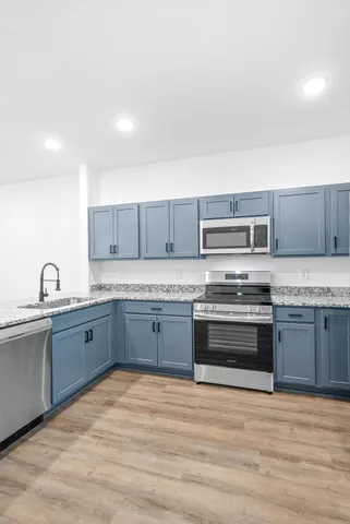 a kitchen with granite countertop a sink and a large mirror