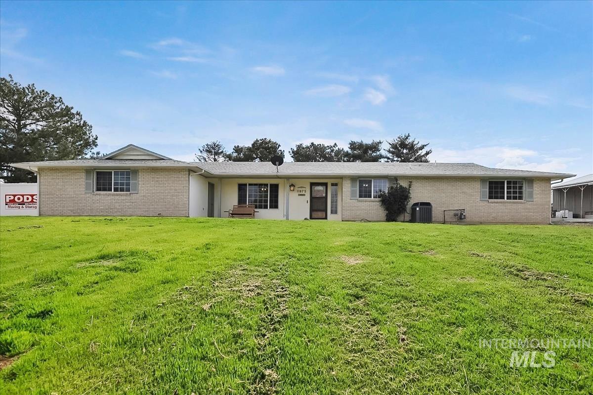 Ranch-style house with brick siding and a front lawn