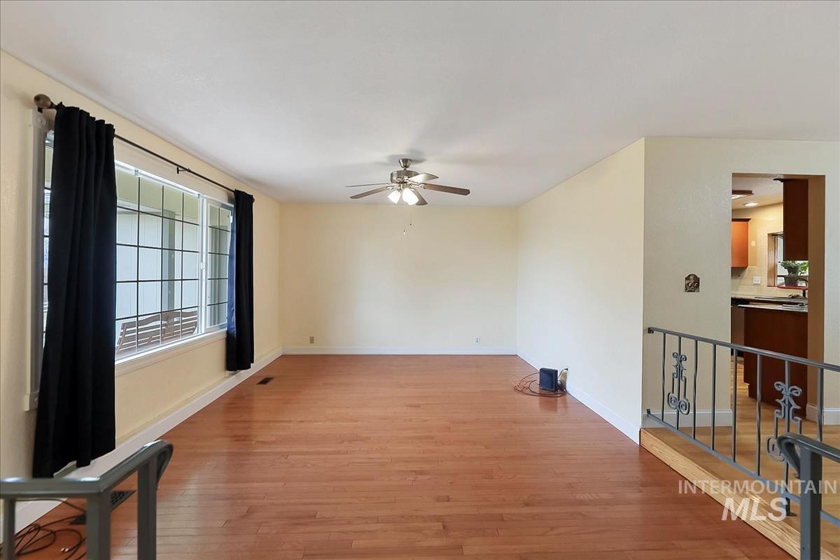 11875 West Hidden Valley Rim Road Boise, ID 83709 - Photo 13 of 36 Unfurnished room with hardwood / wood-style flooring and ceiling fan