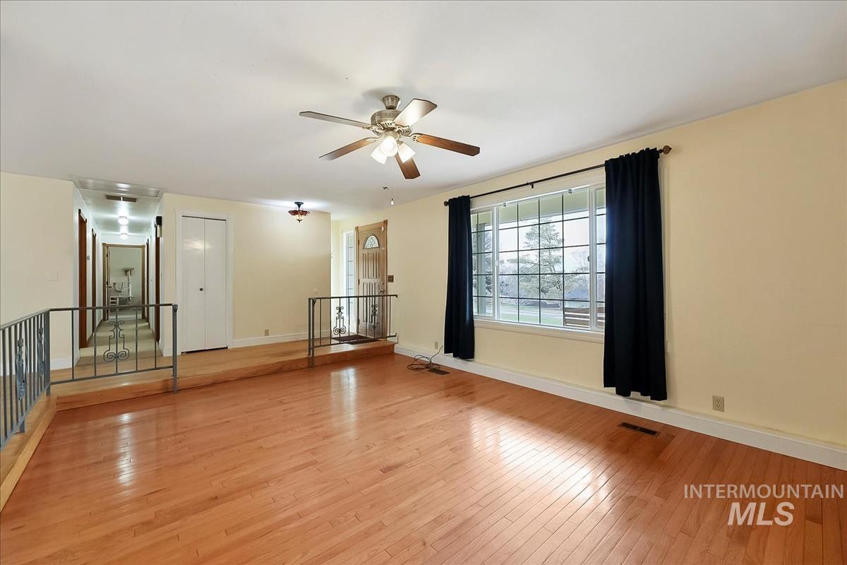 11875 West Hidden Valley Rim Road Boise, ID 83709 - Photo 14 of 36 Unfurnished room with light wood-style floors and a ceiling fan