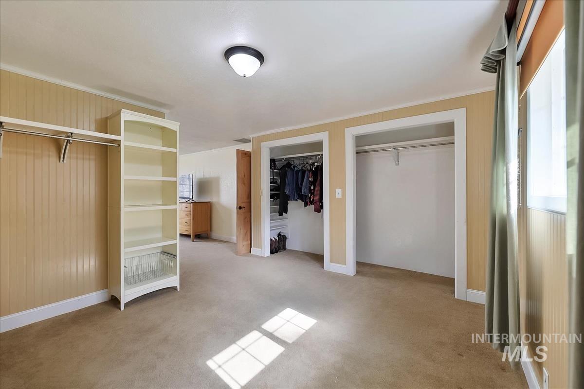 11875 West Hidden Valley Rim Road Boise, ID 83709 - Photo 21 of 36 Unfurnished bedroom with multiple closets and light colored carpet
