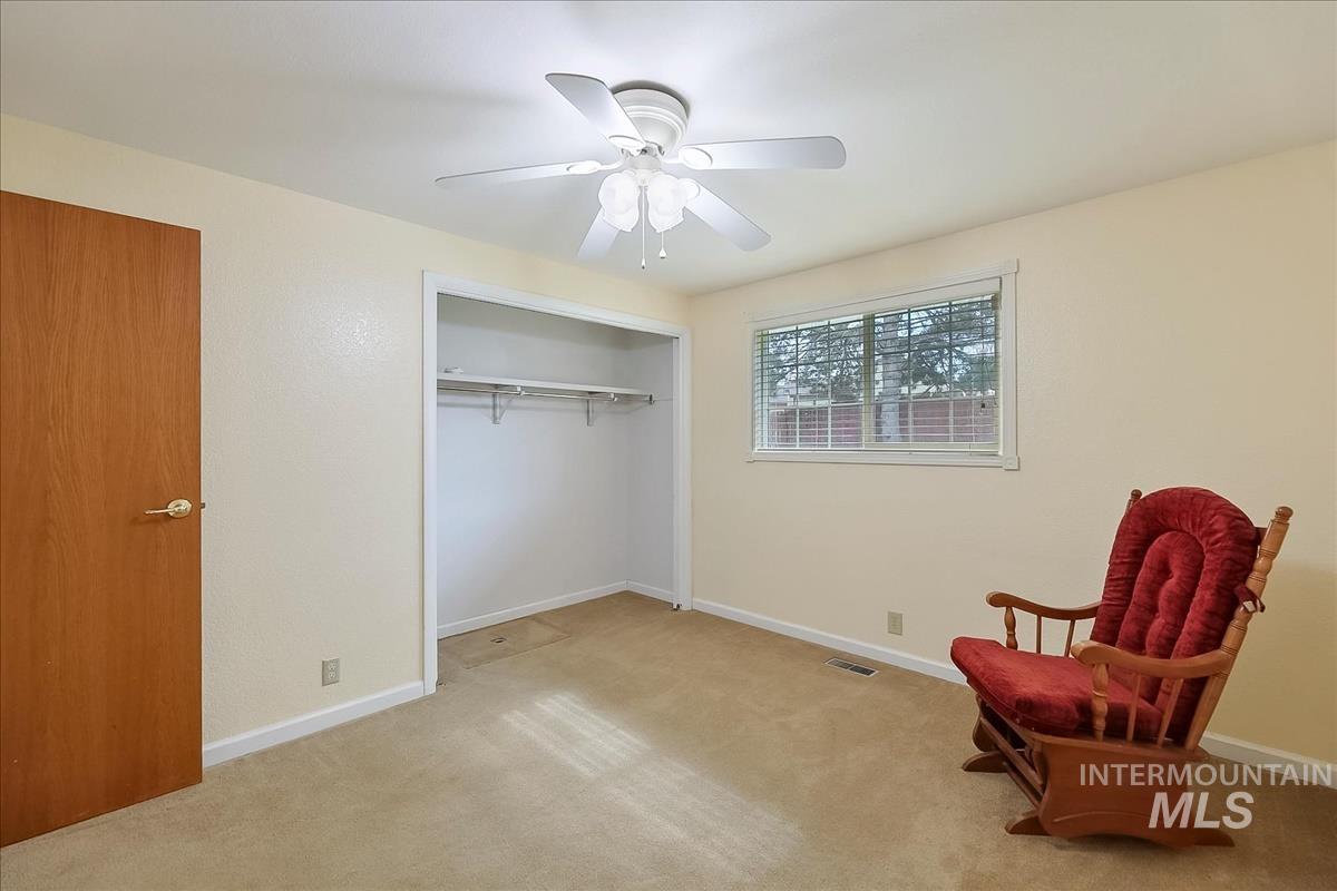 11875 West Hidden Valley Rim Road Boise, ID 83709 - Photo 24 of 36 Living area with a ceiling fan and light colored carpet