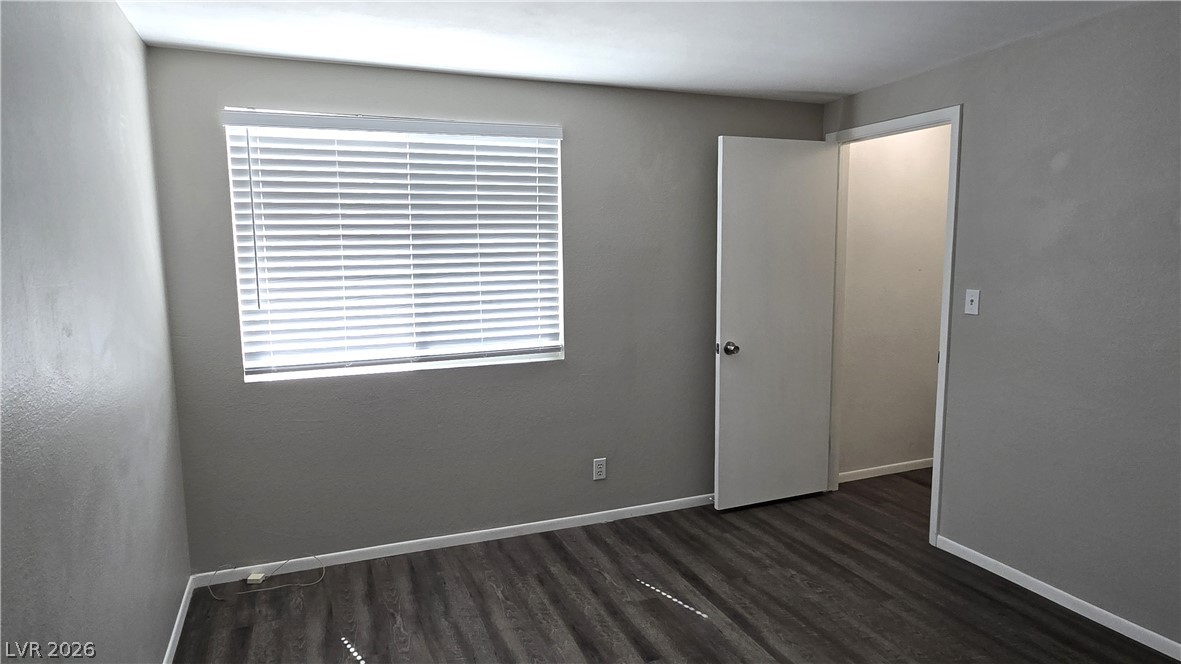 3849 Reflection Way Las Vegas, NV 89147 - Photo 18 of 25 This ample bedroom showcases resilient wood flooring and a window offering natural illumination.