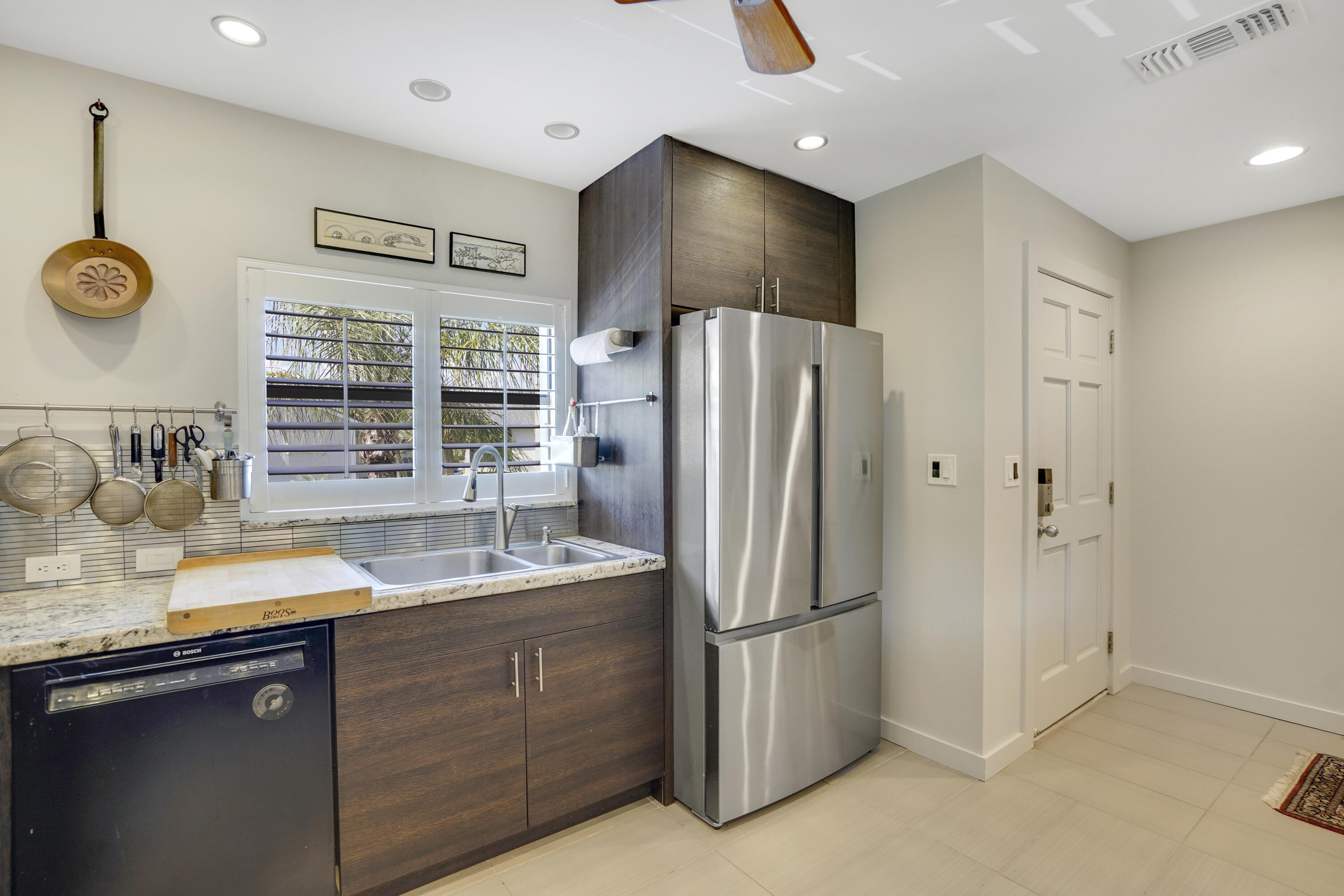 102 Clubhouse Circle Jupiter, FL 33477 - Photo 14 of 35 a kitchen with stainless steel appliances granite countertop a refrigerator and a sink