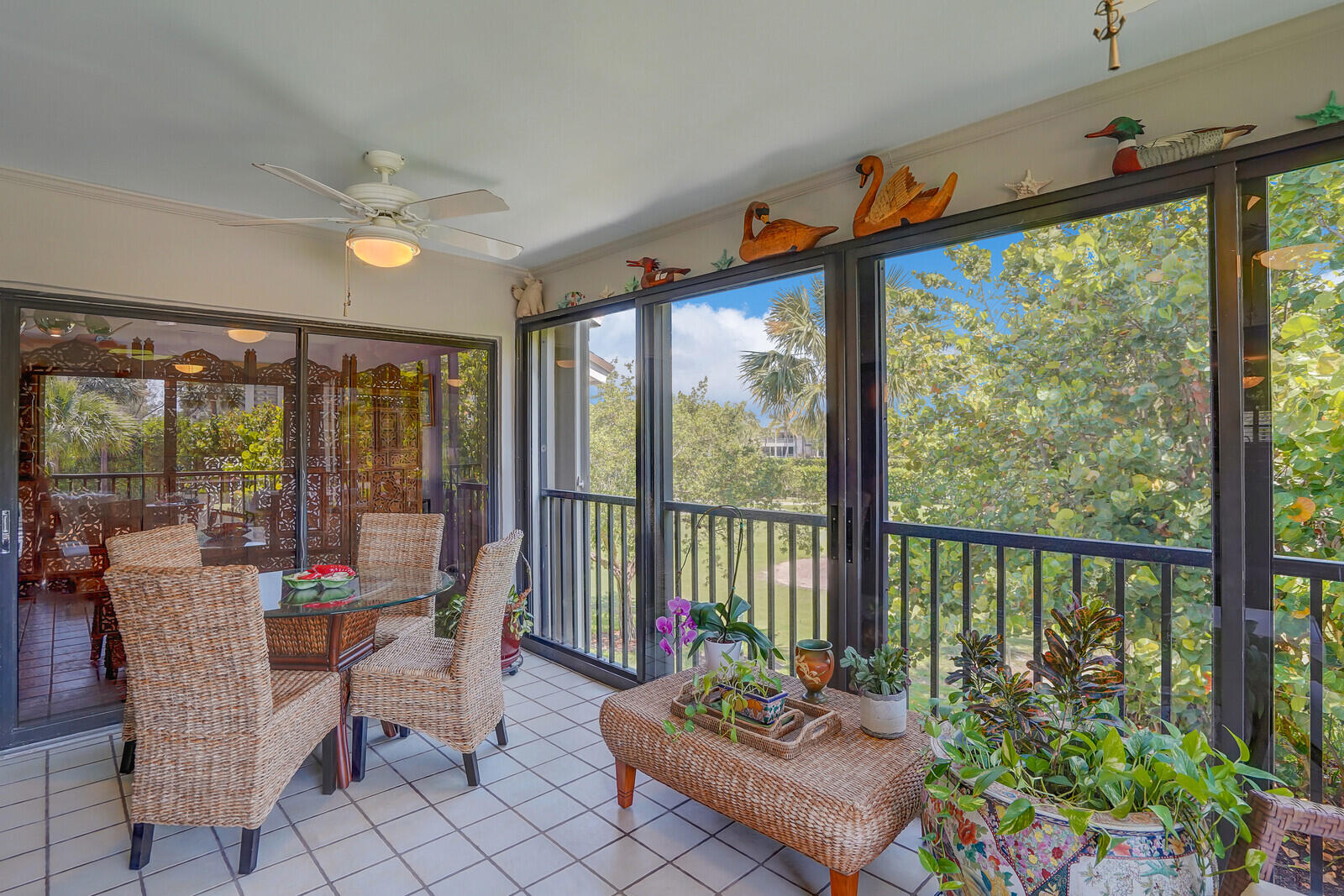 102 Clubhouse Circle Jupiter, FL 33477 - Photo 26 of 35 a living room filled with furniture and a potted plant