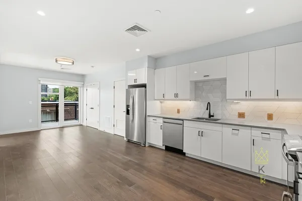 a kitchen with stainless steel appliances sink refrigerator and cabinets