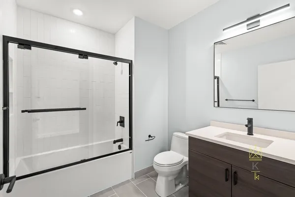 a bathroom with a sink mirror vanity and toilet