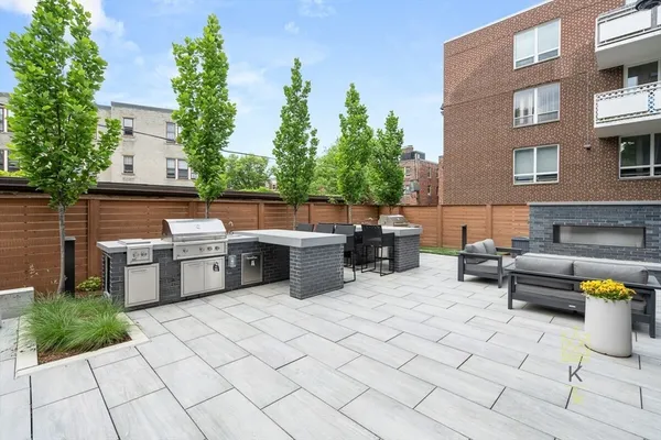 a view of a patio with dining table and chairs with plants and trees