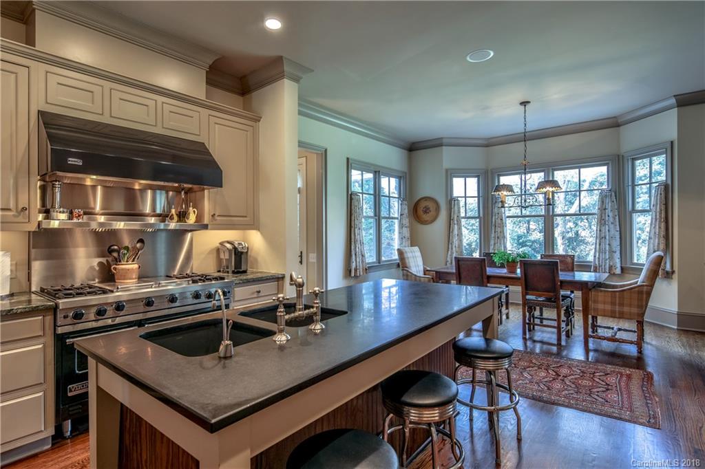 2000 Harris Road Charlotte, NC 28211 - Photo 11 of 34 a kitchen with a table chairs and wooden floor