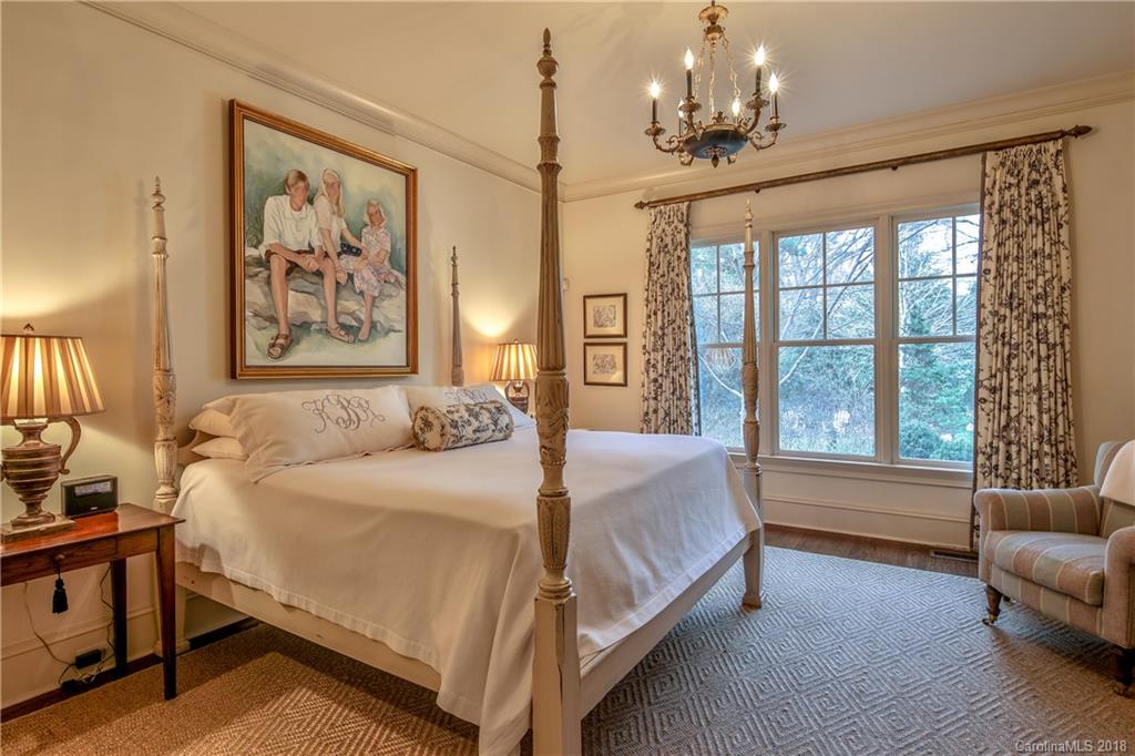 2000 Harris Road Charlotte, NC 28211 - Photo 18 of 34 a spacious bedroom with a bed a couch and a chandelier