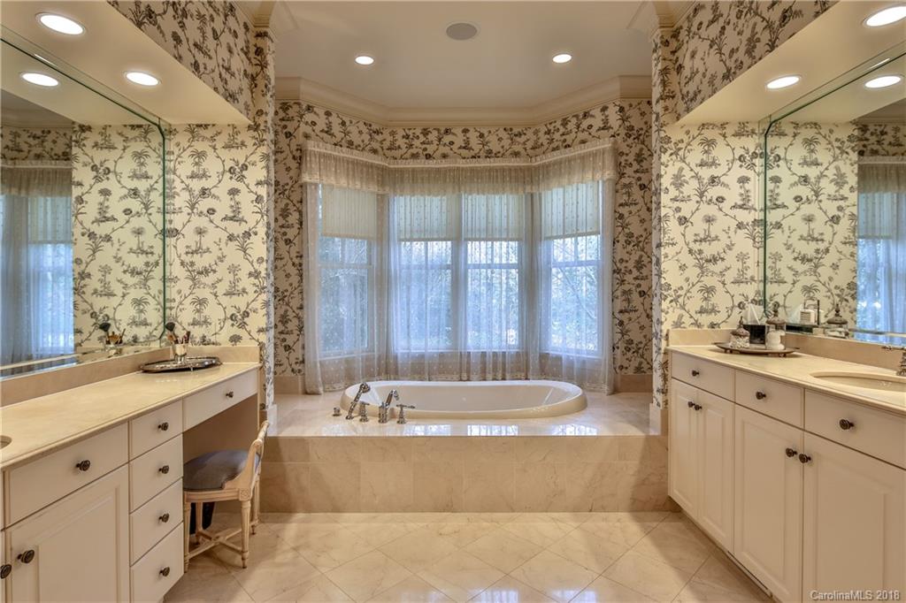 2000 Harris Road Charlotte, NC 28211 - Photo 20 of 34 a bathroom with a tub a sink double vanity and a shower