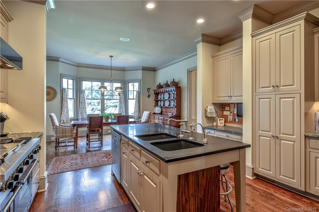 2000 Harris Road Charlotte, NC 28211 - Photo 10 of 34 a kitchen with granite countertop a sink appliances and wooden floor