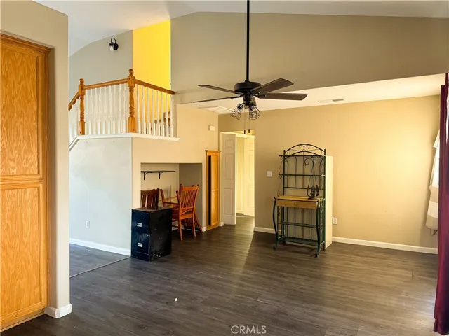 a view of a livingroom with furniture and a ceiling fan