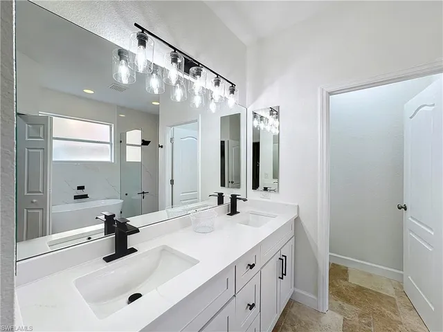 a bathroom with a sink double vanity and a mirror