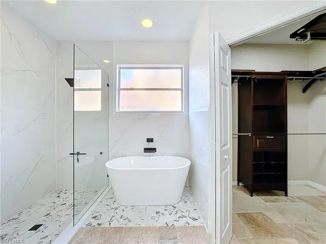 a bathroom with a bathtub and shower