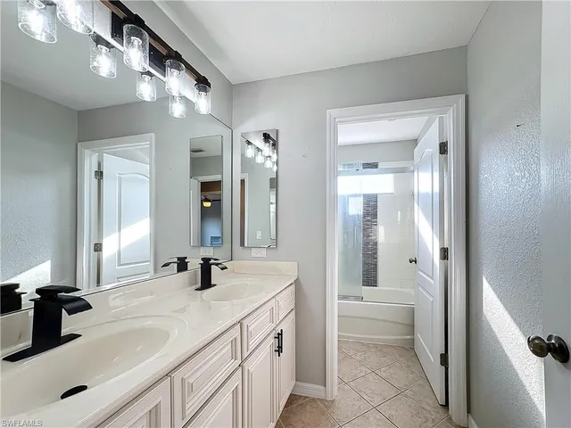 a spacious bathroom with a double vanity sink mirror and shower