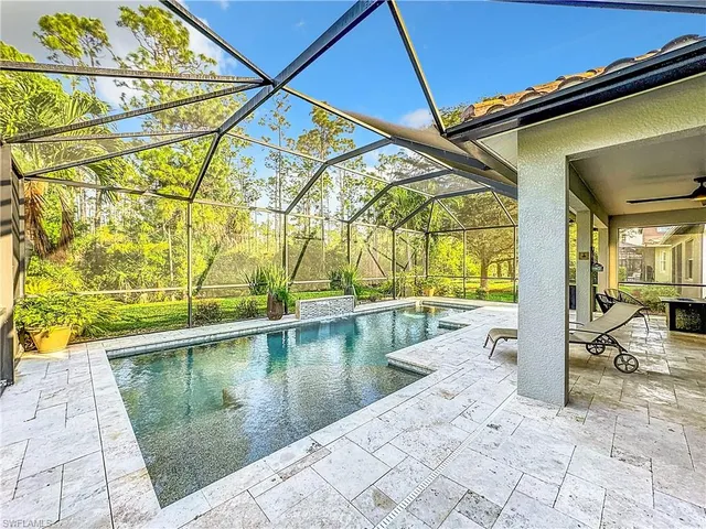 a porch with a bench and chairs