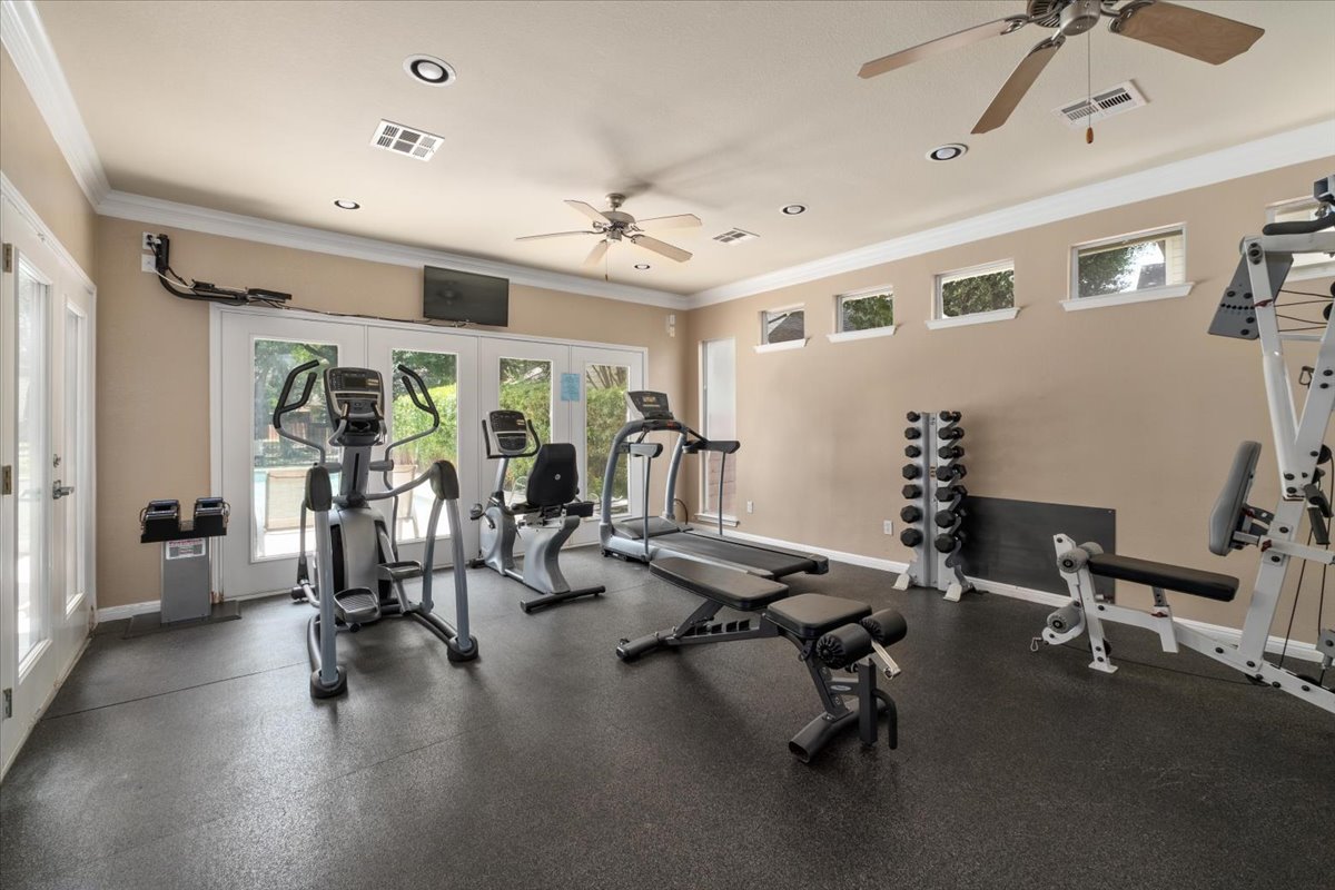 11000 Anderson Mill Road, Unit 11 Austin, TX 78750 - Photo 31 of 34 An inviting home gym with multiple workout stations and French doors leading to outdoor leisure.