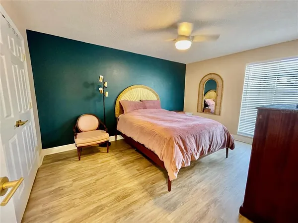 a bedroom with a bed and a chandelier