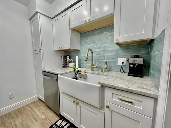 a kitchen with stainless steel appliances granite countertop a sink stove and cabinets