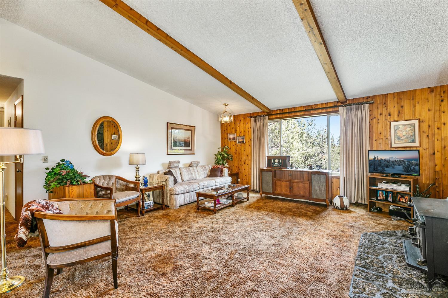 63236 Overtree Road Bend, OR 97701 - Photo 10 of 23 a living room with fireplace furniture and a large window