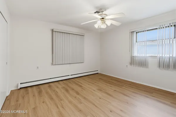 a bathroom with a toilet a sink a bath tub and mirror