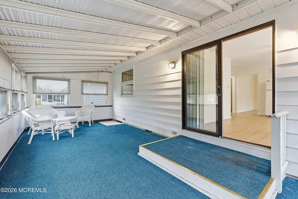 a view of pool with lawn chairs and iron fence