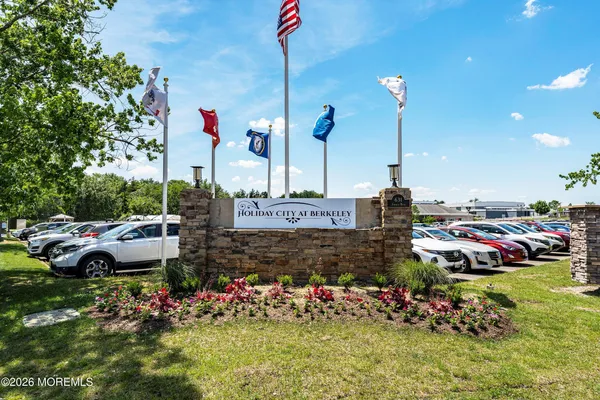 a view of a swimming pool with a bench and trees around
