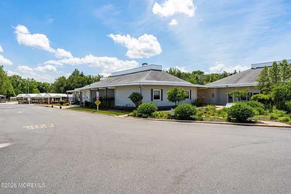 a swimming pool view with a seating space and a garden view