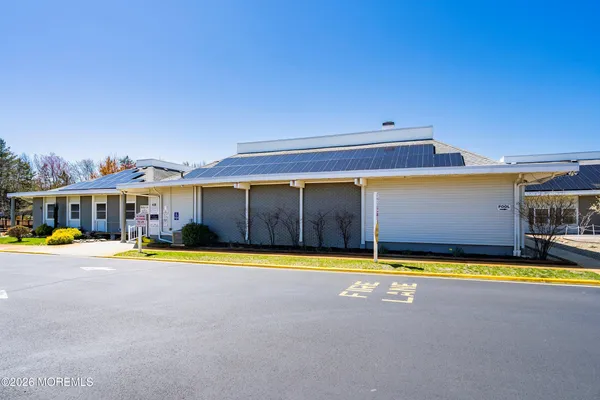 a front view of a house with swimming pool garden and outdoor seating