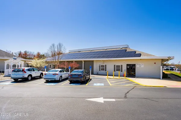a view of a lake with a yard and large trees