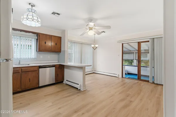 an empty room with cabinet and windows