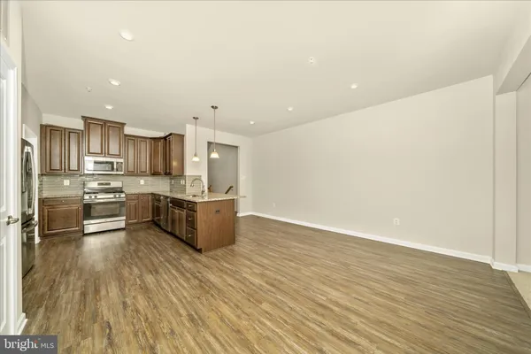 a kitchen with stainless steel appliances a refrigerator and a stove top oven